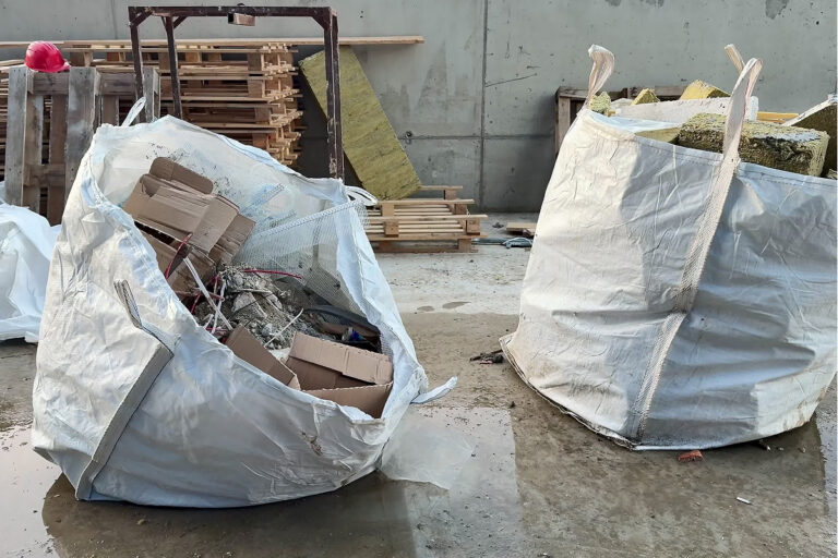 Bags of Asbestos lie ready to be transported. North Elm stands ready to help you get rid of the unwanted and dangerous materials in your projects.